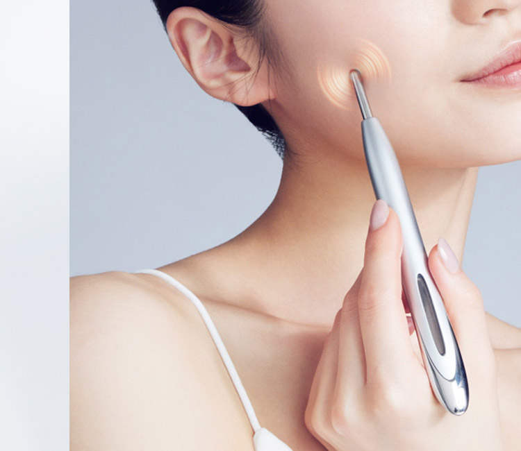 ペン型美顔器で頬をケアする女性の使用イメージ